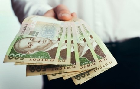 A hand holding a fanned out currencyAI-generated content may be incorrect.